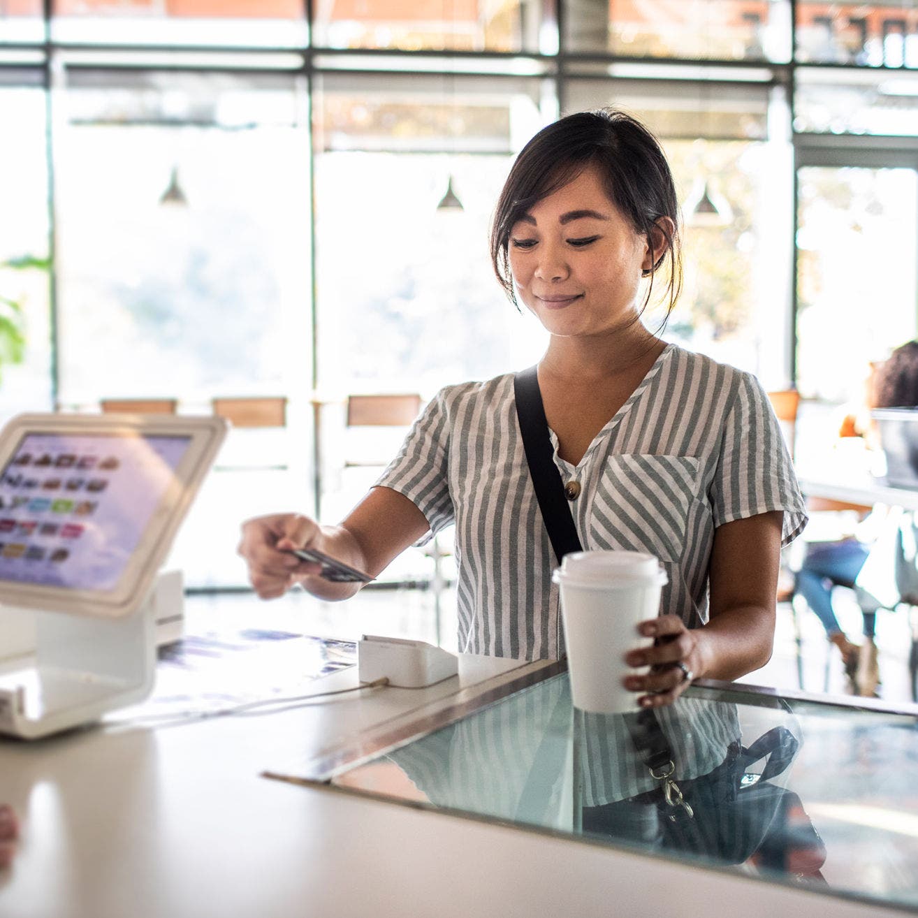 woman paying for coffee