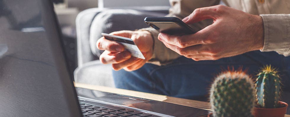 Person holding a credit card. 