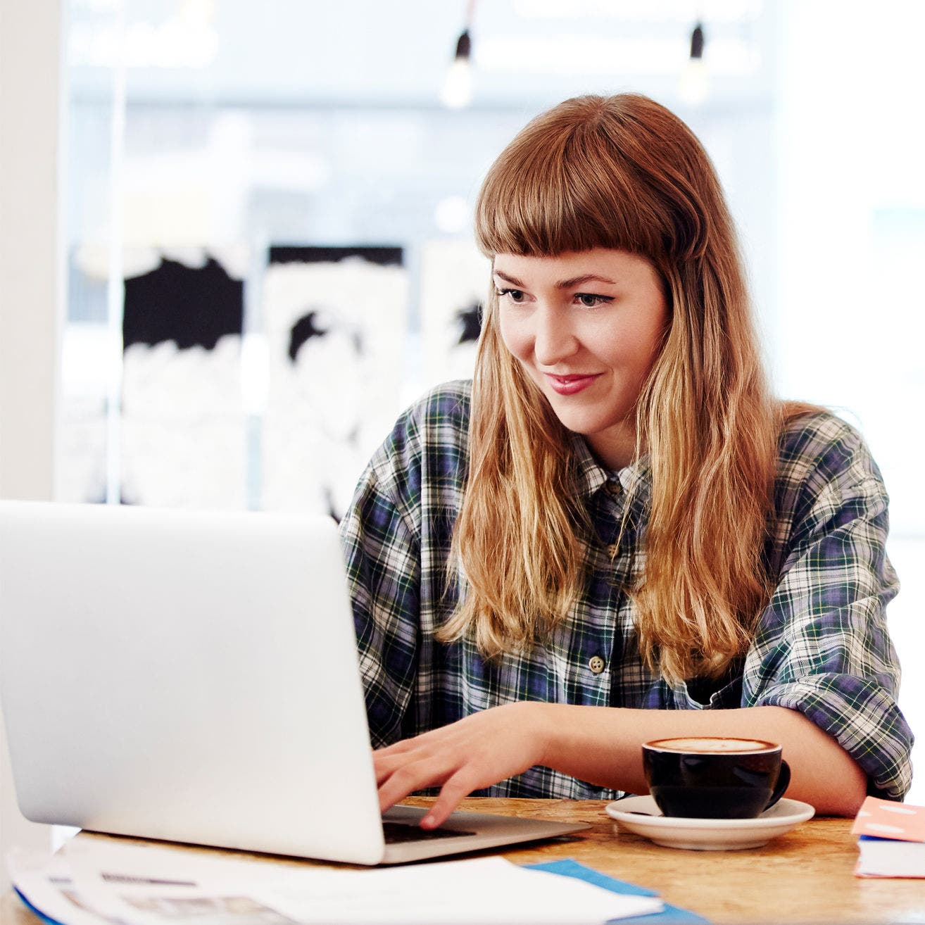 woman working on laptop in coffee shop