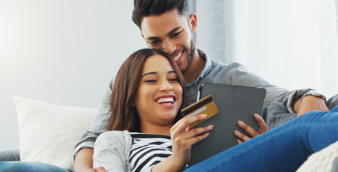 man and woman with table holding credit card